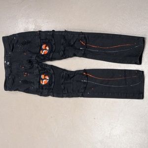 DISTRESSED BLACK FOCUS JEANS WITH ORANGE AND GREY PAINT SPLATTERS AND PATCHES